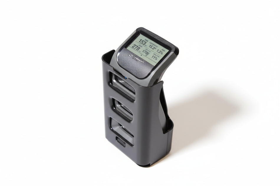 Black electronic device with digital display on a green surface